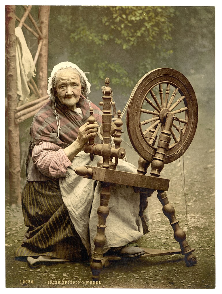 An elderly Irish woman at a spinning wheel